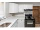 Well-lit kitchen featuring white cabinets, quartz countertops and modern appliances at 4281 Welbron Dr, Decatur, GA 30035