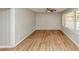 Bright living room featuring laminate wood flooring, a ceiling fan, and a large window at 4281 Welbron Dr, Decatur, GA 30035