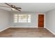 Bright living room featuring laminate wood flooring, a ceiling fan, and a large window at 4281 Welbron Dr, Decatur, GA 30035