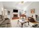 Cozy living room featuring a fireplace, piano, and comfortable seating arrangement at 524 Plantation Creek Dr, Loganville, GA 30052