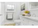 Bright bathroom features a marble-top vanity, white cabinets, and neutral walls at 706 S Grand Nw Ave, Atlanta, GA 30318