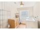 Bright laundry room with appliances, wood cabinets, and beadboard walls at 706 S Grand Nw Ave, Atlanta, GA 30318