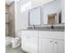 Modern bathroom featuring a dual-sink vanity with granite countertops and sleek white cabinets, plus tiled tub with shower at 813 Smith Sw St # B, Atlanta, GA 30310