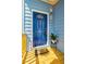 A vibrant blue front door complemented by a decorative pot and a welcoming 'HOME' doormat at 813 Smith Sw St # B, Atlanta, GA 30310
