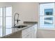 Granite countertop featuring a stainless steel kitchen sink with a modern pull-down faucet at 813 Smith Sw St # B, Atlanta, GA 30310