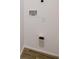 A utility room with a designated area for washer and dryer hookups, featuring wood look tile flooring at 813 Smith Sw St # B, Atlanta, GA 30310