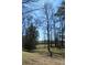 Lush backyard featuring mature trees, a well-maintained lawn, and peaceful views at 2184 E Cherokee Dr, Woodstock, GA 30188