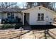 Welcoming home with a cozy front porch and beautifully landscaped garden at 2184 E Cherokee Dr, Woodstock, GA 30188