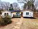 Charming single story home with inviting front porch, stone walkway, and attractive landscaping at 2184 E Cherokee Dr, Woodstock, GA 30188