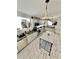 Bright kitchen with stainless steel appliances, white cabinetry, and a stylish central island at 2184 E Cherokee Dr, Woodstock, GA 30188