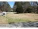 A for sale sign sits roadside, hinting at a promising investment opportunity at 2184 E Cherokee Dr, Woodstock, GA 30188