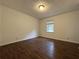 This cozy bedroom features a window offering natural light and beautiful and dark hardwood floors at 2717 Rosemont Dr, Lawrenceville, GA 30044