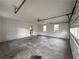 Spacious garage with windows, concrete floor, paneled walls and access to the kitchen at 2717 Rosemont Dr, Lawrenceville, GA 30044