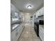Spacious kitchen with white cabinets, granite countertops, tile flooring and stainless steel appliances at 2717 Rosemont Dr, Lawrenceville, GA 30044