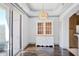 Bright dining area with balcony access, hardwood floors, and decorative lighting at 3445 Stratford Ne Rd # 502, Atlanta, GA 30326
