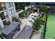 Aerial view of the outdoor patio and tennis court, highlighting community amenities and landscaping at 3445 Stratford Ne Rd # 502, Atlanta, GA 30326