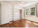 Charming bedroom features hardwood floors, a ceiling fan, and built-in shelving at 3542 W Hill St, Clarkston, GA 30021