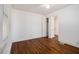 A bedroom with hardwood floors, two windows, and white walls at 3542 W Hill St, Clarkston, GA 30021