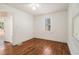 This bedroom features hardwood floors, one window, and an interior door at 3542 W Hill St, Clarkston, GA 30021