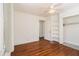 Bright bedroom features hardwood floors, a ceiling fan, and a closet with built in shelves at 3542 W Hill St, Clarkston, GA 30021