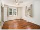 Sunlit bedroom with ceiling fan, hardwood floors, and natural light at 3542 W Hill St, Clarkston, GA 30021