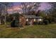 Cozy brick home exterior at dusk, showcasing its well-maintained lawn and landscaping at 3542 W Hill St, Clarkston, GA 30021