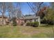 Quaint brick home with a green lawn and landscaping at 3542 W Hill St, Clarkston, GA 30021