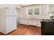 This home's functional kitchen features a white refrigerator and plenty of cabinet space at 3542 W Hill St, Clarkston, GA 30021