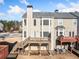 Townhome featuring a rear deck, neutral siding, and a chimney for added charm at 1296 Park Pass Way, Suwanee, GA 30024