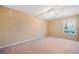 Spacious bedroom with plush carpet, ample natural light, and ceiling fan at 1296 Park Pass Way, Suwanee, GA 30024