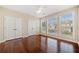 Bedroom with hardwood floors, a ceiling fan, and large windows for plenty of natural light at 1296 Park Pass Way, Suwanee, GA 30024