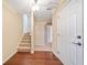 Bright entryway featuring hardwood floors, staircase, and white trim at 1296 Park Pass Way, Suwanee, GA 30024