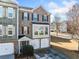 Inviting two-story brick townhouse featuring a two-car garage, front yard greenery, and classic architectural details at 1296 Park Pass Way, Suwanee, GA 30024
