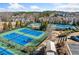 Tennis courts featuring multiple well-maintained courts, lush landscaping, and ample parking at 1296 Park Pass Way, Suwanee, GA 30024