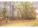Wooded backyard with black metal fence and a variety of shade trees at 247 Brookview Dr, Riverdale, GA 30274