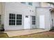 An ample concrete backyard patio featuring a white door and exterior storage at 247 Brookview Dr, Riverdale, GA 30274