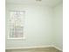 Inviting bedroom featuring neutral walls, wood-look flooring, and a bright window at 247 Brookview Dr, Riverdale, GA 30274