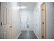 Well-lit hallway with multiple closets, hard surface flooring and access to front door at 247 Brookview Dr, Riverdale, GA 30274