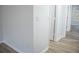 Neutral hallway featuring wood-look floors and white trim at 247 Brookview Dr, Riverdale, GA 30274
