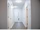 Bright hallway with neutral paint, wood-look flooring, and a white front door with sidelight window at 247 Brookview Dr, Riverdale, GA 30274