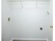 Bright laundry room with overhead shelving and utility connections at 247 Brookview Dr, Riverdale, GA 30274