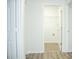 A view of a laundry room with new flooring, a wire shelf, and a white door at 247 Brookview Dr, Riverdale, GA 30274