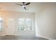 Bright living room with large windows offering natural light and hard surface flooring at 247 Brookview Dr, Riverdale, GA 30274