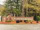 Community sign for Brookview Village surrounded by brick walls, landscaping and trees at 247 Brookview Dr, Riverdale, GA 30274