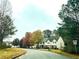Street view of homes in a community neighborhood with mature trees and landscaping at 247 Brookview Dr, Riverdale, GA 30274