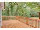 Expansive wooden deck with a beautiful view of the lush, tree-filled backyard at 2598 Elliott Nw St, Atlanta, GA 30318