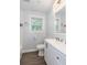 Bright bathroom featuring a white vanity, toilet, and a window for natural light at 2598 Elliott Nw St, Atlanta, GA 30318