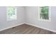 Well-lit bedroom with two windows and hardwood flooring at 2598 Elliott Nw St, Atlanta, GA 30318