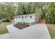 A single-story home featuring a blue front door, updated siding, concrete driveway and manicured front yard at 2598 Elliott Nw St, Atlanta, GA 30318