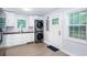 Updated kitchen featuring white cabinetry, modern appliances, stacked laundry, and hardwood floors at 2598 Elliott Nw St, Atlanta, GA 30318